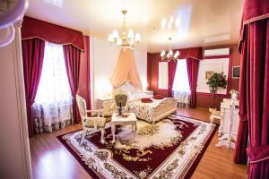 a bedroom with a bed and a chandelier at 13 Chairs Boutique Hotel in Petrozavodsk