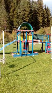 a playground in a field with a slide at Apartmány Božka in Terchová