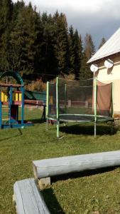 a park with a bench and a playground at Apartmány Božka in Terchová