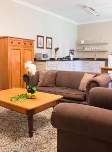 a living room with a couch and a coffee table at Pond End Villa in Clarens