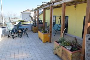 a patio with a table and chairs on a balcony at La Scogliera B&B in San Vito Chietino