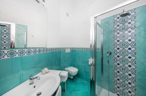 a bathroom with a toilet and a sink and a shower at Hotel Pupetto in Positano