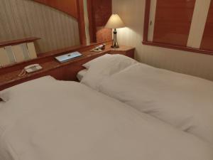 a hotel room with two beds and a mirror at Hotel Hyper Noah (Adult Only) in Sakai