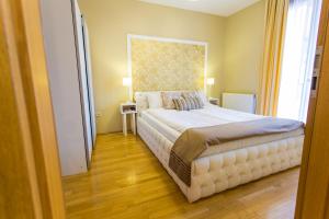 a bedroom with a bed and a dresser at Colours Apartments Budapest in Budapest