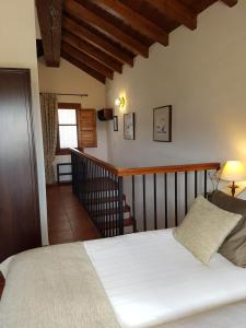 a bedroom with a white bed and a staircase at Bed & Breakfast | Guest House Casa Don Carlos in Alhaurín el Grande