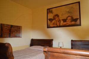 a bedroom with a bed and a painting on the wall at Il Borgo in Sanfront