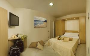 a hotel room with a bed and a tv at Residence Continental Resort in Gabicce Mare +50 photos