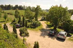 a group of three cars parked in a driveway at Agroturystyka Zielone Wzgorze in Sikorzyno