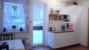 a kitchen with a window and a counter with a microwave at Fischer in Clausthal-Zellerfeld +16 photos