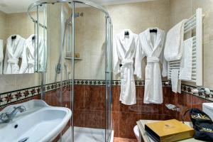 a bathroom with a sink and a shower with white towels at GKK Exclusive Private suite Venezia in Venice