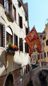 a flag hanging from the side of a building at Hotel Casa Petrarca in Venice
