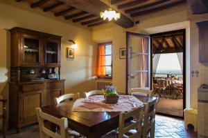 a dining room with a table and chairs and a window at La Terrazza in Chianni