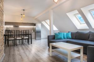 a living room with a couch and a table at Garden apartments in Prešov