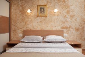 a bedroom with a bed with two pillows at Apartments Kate in Makarska