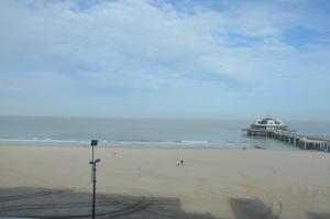 a view of a beach with a pier and the ocean at Apartment Beach in Blankenberge