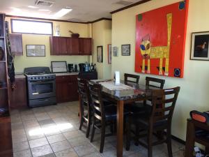 a kitchen with a table and chairs in a room at Sofia Apartments in Escalante, San Jose Center in San José