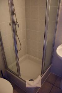 a shower in a bathroom with a toilet and a sink at Condo Gardens Antwerp in Antwerp +59 photos
