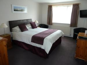 Tempat tidur dalam kamar di The Winsford Lodge