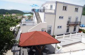 a large white building with a red roof at Apartments Villa Dadora in Sutomore