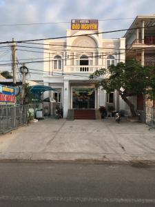 a large white building with a sign on it at Khách Sạn Đào Nguyên in Tuy Phong +16 photos