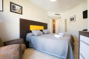 Posteľ alebo postele v izbe v ubytovaní Hotel Montmar