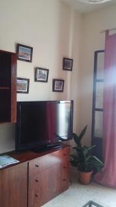 a living room with a flat screen tv on a dresser at Apartamento Zulema in Aracena