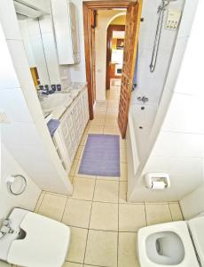 a bathroom with a sink and a toilet at Apartment Paraiso Royal in Playa de las Americas