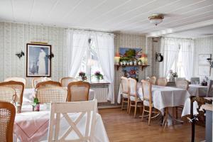 a dining room with a table and chairs and a room with tables and chairsktop at Hotell & Restaurant Solliden in Stenungsund