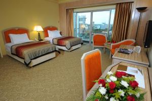 Voodi või voodid majutusasutuse Grand Darul Makmur Hotel Kuantan toas