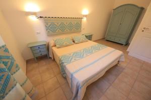 a bedroom with two beds and a green cabinet at ### Appartamenti sulla SPIAGGIA al POETTO ### in Cagliari