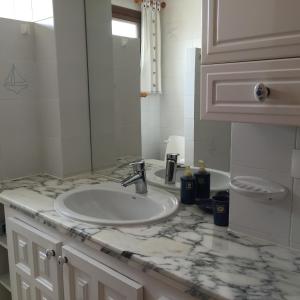 a bathroom with a sink and a white counter top at Apartment Paraiso Royal in Playa de las Americas
