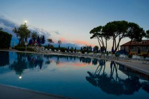 a large pool of water with a sunset in the background at Fantinello Hotel in Caorle