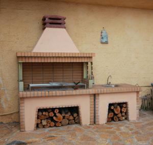 a brick oven with a bunch of logs in it at Romanza Studios in Vasiliki