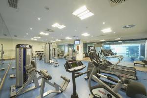 a gym with several treadmills and cardio machines at Grande Real Santa Eulalia Resort & Hotel Spa in Albufeira