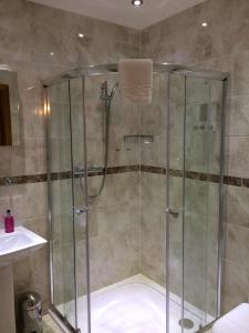 a shower with a glass door in a bathroom at Glen-Lyn in Robin Hood's Bay