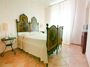a bedroom with a large bed and a table at Casale Sant'Angelo in Capalbio
