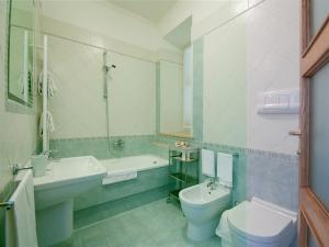 a bathroom with a sink and a toilet and a tub at Casale Sant'Angelo in Capalbio +27 photos