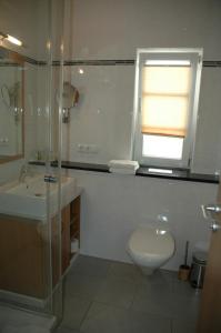 a bathroom with a sink and a toilet and a window at Ferienhaus am Brunnen in Tiefenpölz