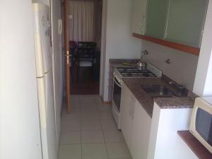 a kitchen with a sink and a stove top oven at Rodriguez in Rosario