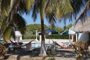 a resort with hammocks and a swimming pool at Condominio Punta Bolivar in San Antero