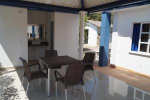 a table and chairs on the patio of a house at Condominio Punta Bolivar in San Antero