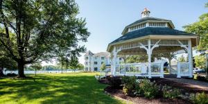 a gazebo in a park with a house in the background at Oakwood Resort in Syracuse