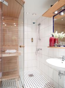 a bathroom with a shower and a sink at Pariisin Ville in Porvoo