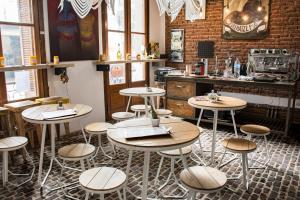 a restaurant with tables and stools in a room at Marcel de Buenos Aires in Buenos Aires