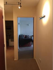 a view of a living room with a couch through a door at Grace's HQ in Aldershot