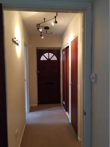 a hallway with a black door and a hallwayngth at Grace's HQ in Aldershot