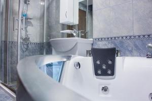 a bathroom with a white tub and a sink at King Hotel in Peje +45 photos