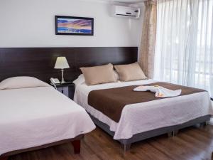 A bed or beds in a room at Hotel & Spa Las Taguas