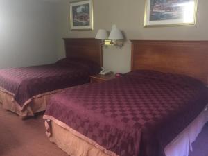 a hotel room with two beds and a phone at America's Best Inn & Suites Eureka in Eureka