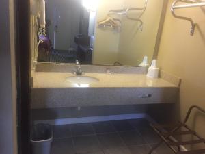 a bathroom with a sink and a mirror at America's Best Inn & Suites Eureka in Eureka